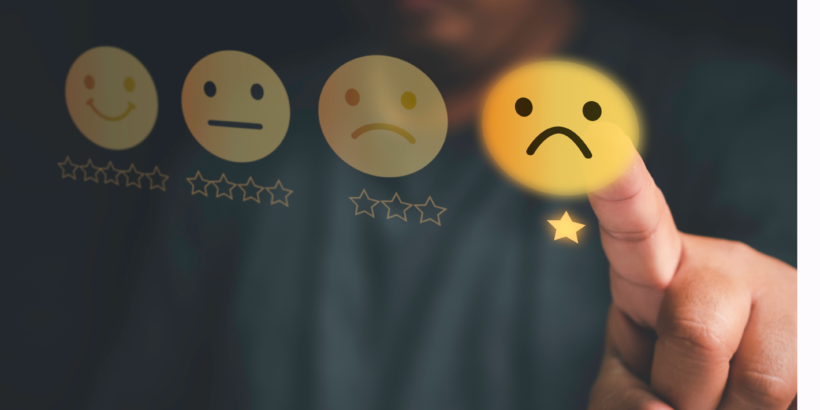 A picture with star ratings and emojis as part of the rating and a hand selecting one star